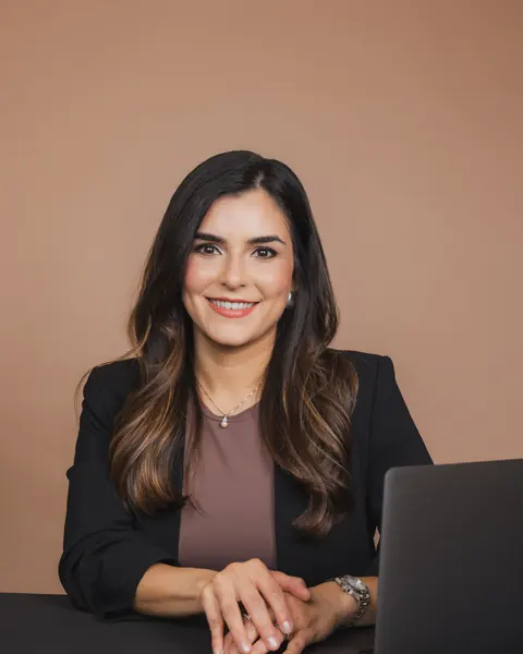 Businesswoman in a black blazer working at her laptop