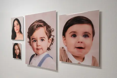 Framed portraits hanging on the studio wall