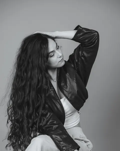 Black and white portrait of a woman in a leather jacket