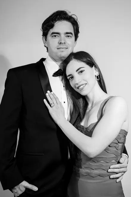 Couple in formal wear, her hand resting on his chest